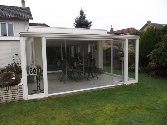 Black aluminum bifold glass doors fully opened connecting indoor living space to outdoor patio area