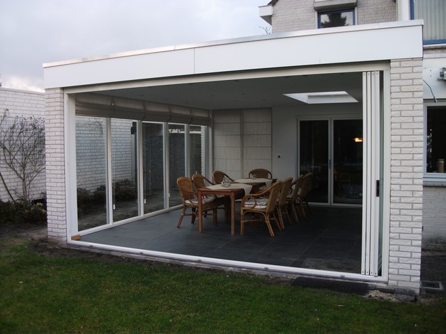 Black aluminum bifold glass doors fully opened connecting indoor living space to outdoor patio area